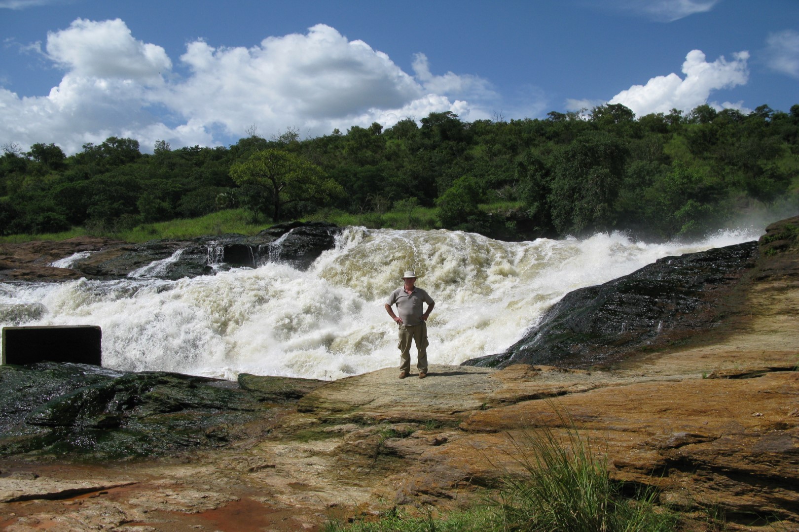 A guest enjoying photo moment at the top of Murchison Falls in Murchison Falls National Park