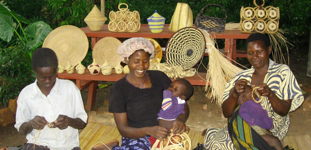 Some of the members of Boomu Women's Group near Murchison Falls National Park weaving crafts.