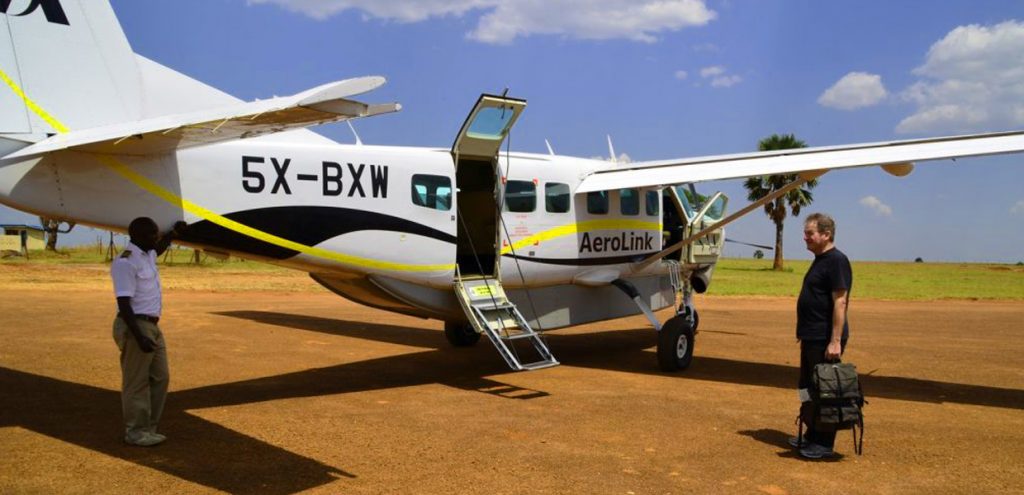 A guest boarding an Aerolink plane at Bugungu Airstrip in Murchison Falls National Park, Uganda