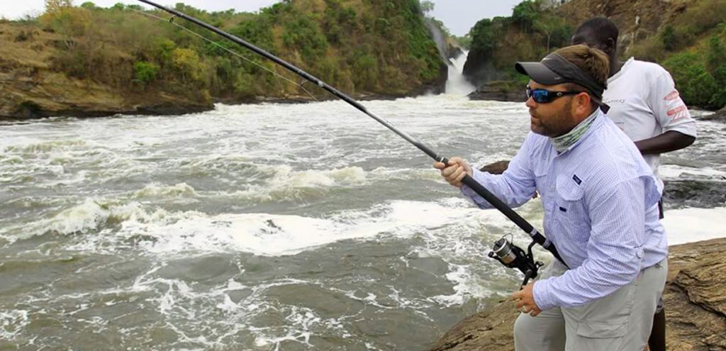 A guest using his fishing gear while on a sport fishing experience in Murchison Falls National Park